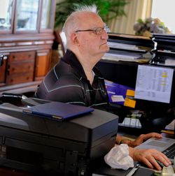 Senior businessman using laptop while working at desk in office