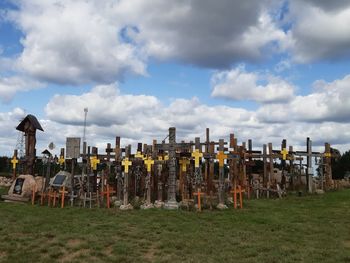 Cemetery on field against sky