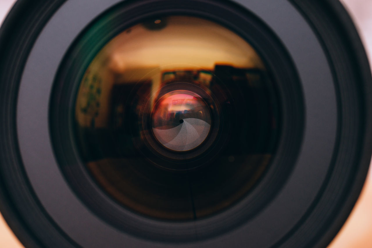 CLOSE-UP REFLECTION OF CAMERA ON MIRROR OF DIGITAL COMPOSITE