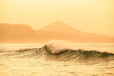 Scenic view of sea against clear sky during sunset