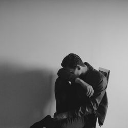 Young woman standing against white background