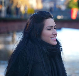 Portrait of a smiling young woman looking away