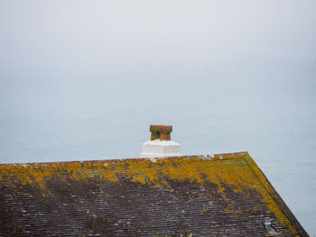 Building by sea against sky