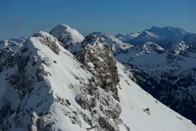 Scenic view of snowcapped mountains against clear sky