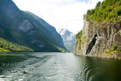 Scenic view of river amidst mountains against sky