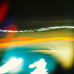 Close-up of illuminated lights against sky at night