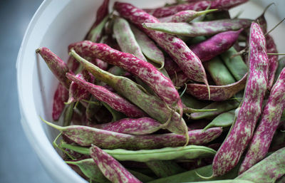 High angle view of purple peas in container