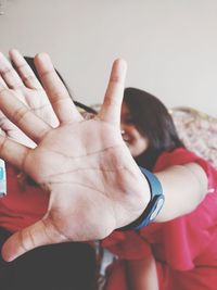 Close-up of woman gesturing stop sign at home