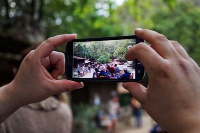 Cropped image of person holding smart phone