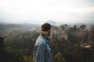 Man standing on mountain against sky