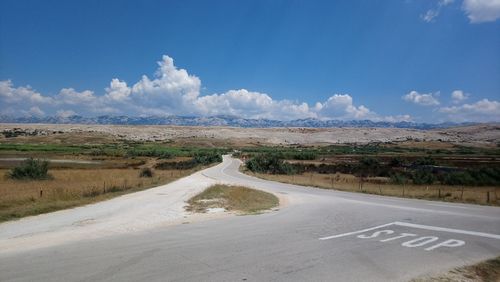 Road passing through landscape against sky