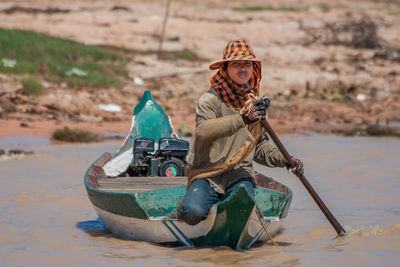 Woman sitting on boat in lake