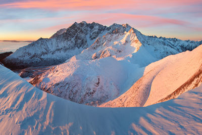 Scenic view of snow covered mountains against sky during sunset