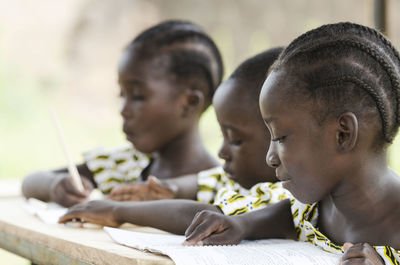 Close-up of girls studying at table