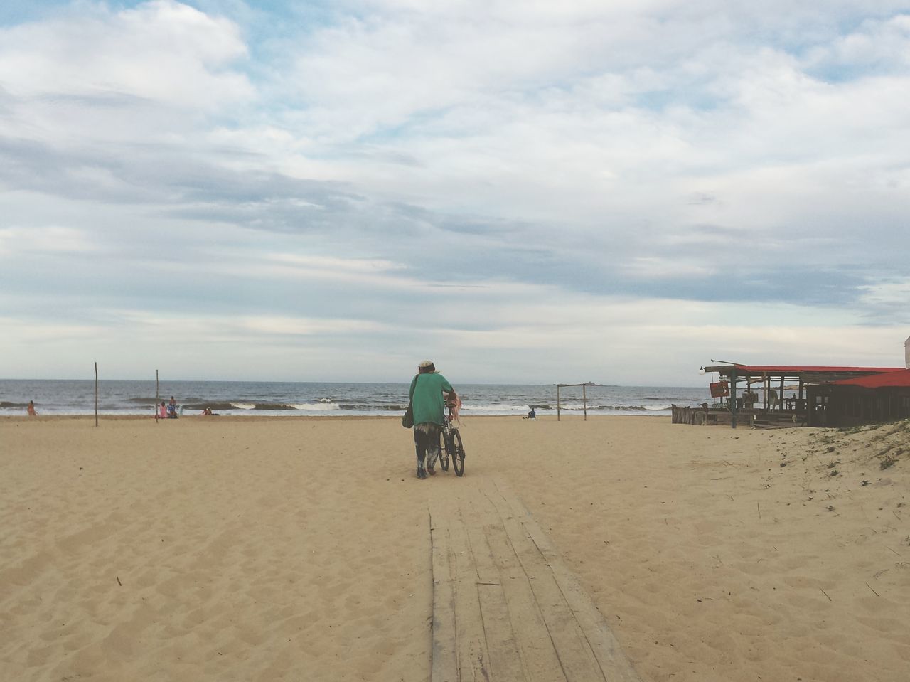 beach, sand, sea, sky, shore, water, horizon over water, lifestyles, rear view, leisure activity, cloud - sky, full length, tranquility, men, person, tranquil scene, vacations, cloud