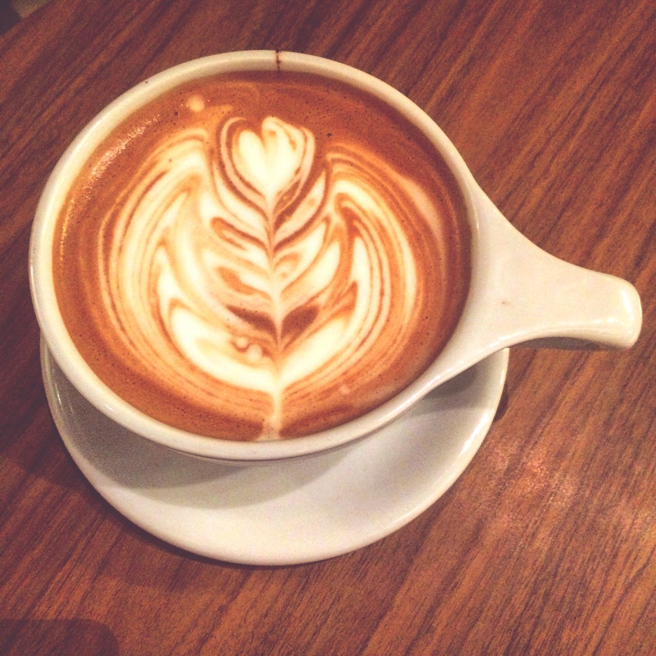 coffee cup, drink, food and drink, refreshment, coffee - drink, table, froth art, cappuccino, frothy drink, saucer, indoors, freshness, coffee, still life, close-up, latte, high angle view, cup, spoon, heart shape