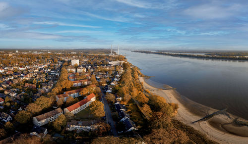 High angle view of river amidst buildings against sky