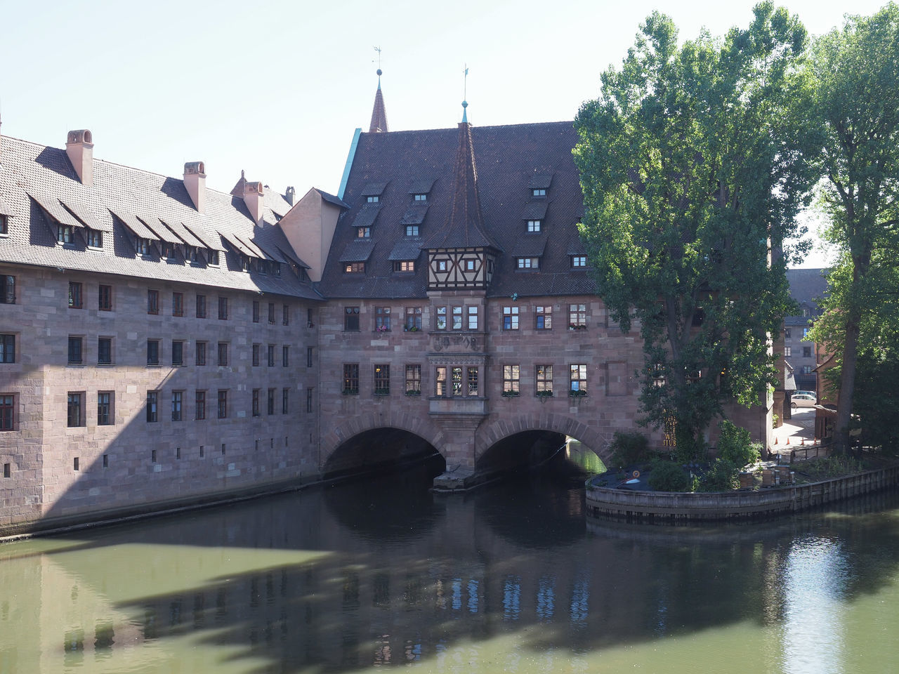 architecture, built structure, water, building exterior, waterway, nature, building, bridge, travel destinations, château, history, the past, river, reflection, city, water castle, tree, travel, tourism, sky, moat, plant, no people, transportation, waterfront, outdoors, day, castle, nautical vessel, clear sky, tower