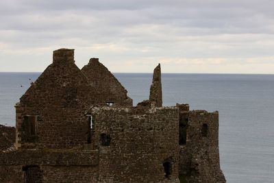 Castle by sea against sky