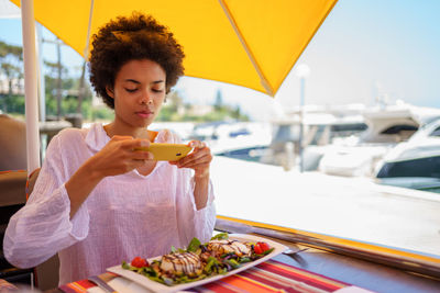 Portrait of young woman holding food