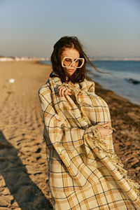 Young woman standing at beach