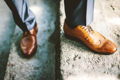 Low section of man with brogue shoes standing on steps