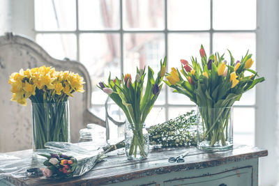 Close-up of yellow tulip in vase on table at home