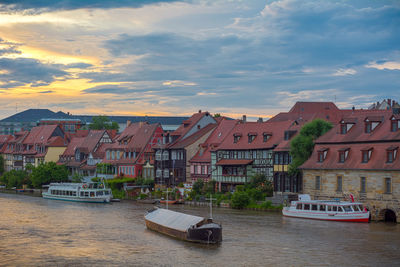 Boats in river with buildings in background