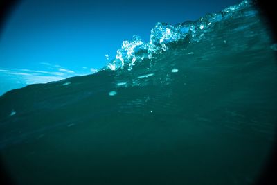 Low angle view of frozen sea against blue sky