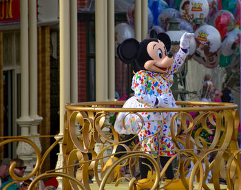 Full length of woman with toy while standing on seat