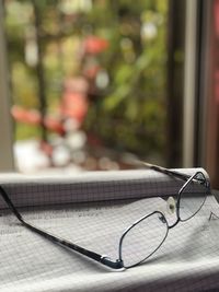 Close-up of eyeglasses on table by window