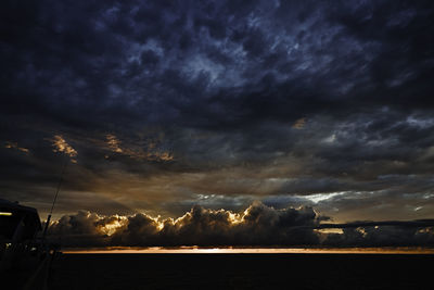 Storm clouds over sea during sunset