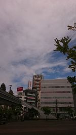 Buildings against cloudy sky