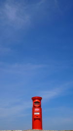 Low angle view of red tower against sky