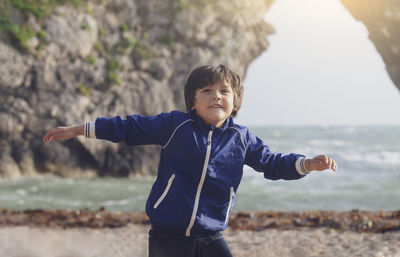 Full length of boy standing against wall