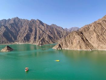 Scenic view of lake with mountain range in background