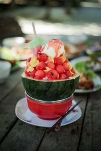 Close-up of strawberry and ice cream on table