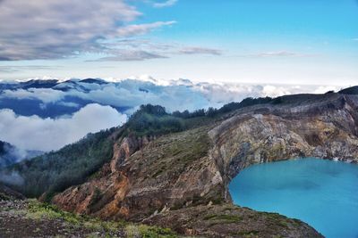 Scenic view of mountains against blue sky