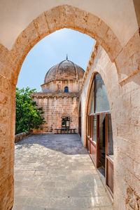 Archway of historic building against sky