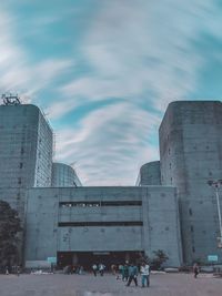 Group of people in historic building against sky