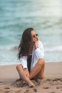 Young woman sitting on beach