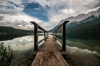 Pier over lake against sky