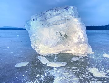 Close-up of ice crystals against sea during winter