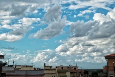 Buildings against cloudy sky