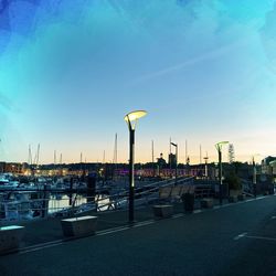 City street against blue sky during sunset