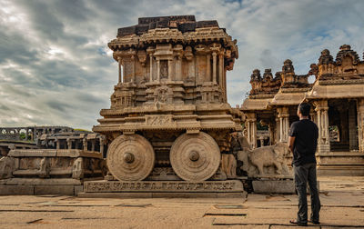 Full length of man standing outside temple against sky