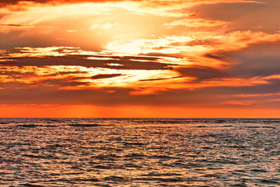 Scenic view of sea against romantic sky at sunset