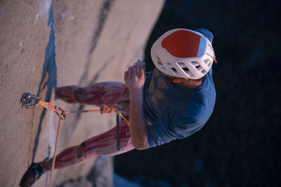 Climber with helmet hanging on wall while trying hard route el capitan