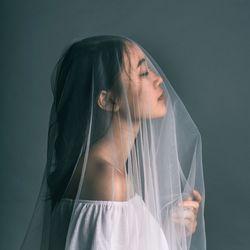 Close-up of young woman covering face