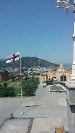 View of buildings against clear blue sky